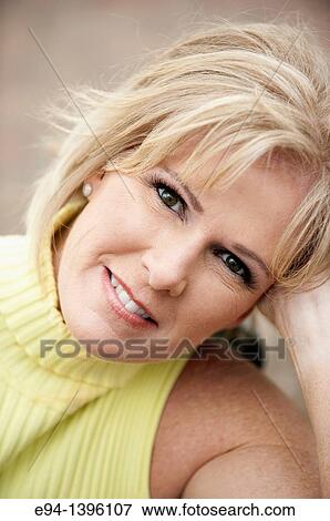 Portrait of a 50 year old blond woman in an outdoor setting smiling at the camera View Large Photo Image Stock Photo - Portrait of a 50 year old blond woman in an outdoor setting smiling at the camera. Fotosearch