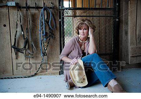 Portrait of a 52 year old blonde woman in casual clothing in a horse barn setting looking at the camera. View Large Photo Image Stock Photo - Portrait of a 52 year old blonde woman in casual clothing in a horse barn setting looking at the camera.. Fotosearch