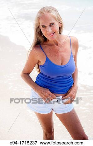 Portrait of a 57 year old woman on a beach smiling at the camera View Large Photo Image Stock Photo - Portrait of a 57 year old woman on a beach smiling at the camera. Fotosearch