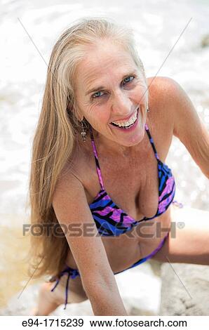 Portrait of a 57 year old woman on a beach smiling at the camera View Large Photo Image Stock Photo - Portrait of a 57 year old woman on a beach smiling at the camera. Fotosearch