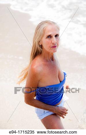 Portrait of a 57 year old woman on a beach looking at the camera View Large Photo Image Stock Photography - Portrait of a 57 year old woman on a beach looking at the camera. Fotosearch