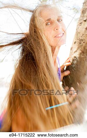 Portrait of a 57 year old woman smiling at the camera View Large Photo Image Stock Image - Portrait of a 57 year old woman smiling at the camera. Fotosearch