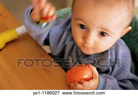 Portrait of a baby girl playing, France. View Large Photo Image Stock Photo - Portrait of a baby girl playing, France.. Fotosearch