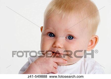 Portrait of a baby with a finger in her mouth. View Large Photo Image Stock Photo - Portrait of a baby with a finger in her mouth.. Fotosearch