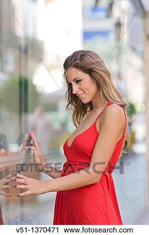 Stock Image - Portrait of a beautiful blonde woman shopping. Fotosearch