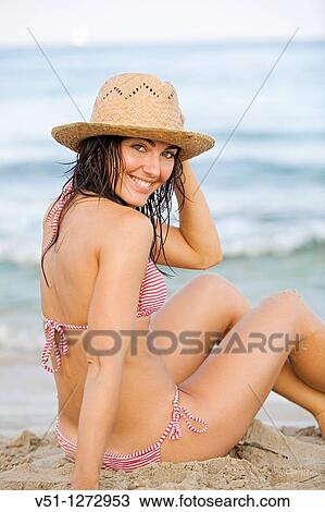 Portrait of a beautiful brunette woman smiling at camera at the beach View Large Photo Image Stock Image - Portrait of a beautiful brunette woman smiling at camera at the beach. Fotosearch