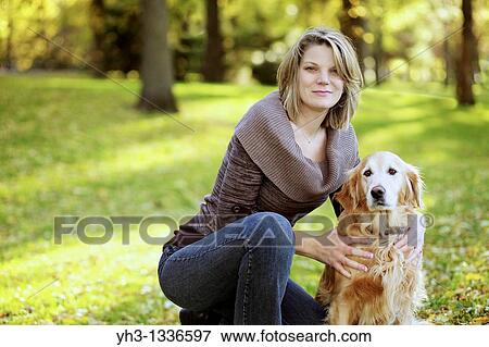 Portrait of a beautiful Caucasian woman with her golden retriever dog at the park View Large Photo Image Stock Photo - Portrait of a beautiful Caucasian woman with her golden retriever dog at the park. Fotosearch