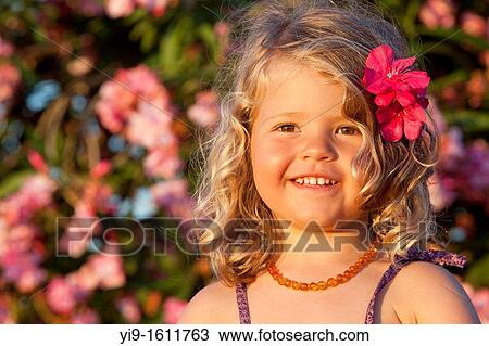 portrait of a beautiful girl with a flower in her hair View Large Photo Image Stock Image - portrait of a beautiful girl with a flower in her hair. Fotosearch