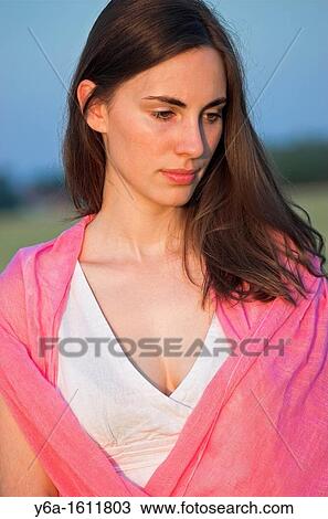 Portrait of a beautiful young woman outdoors looking down View Large Photo Image Stock Image - Portrait of a beautiful young woman outdoors looking down. Fotosearch