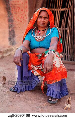 Portrait of a bhil woman in traditional dress sitting, Madhya Pradesh, India. View Large Photo Image Stock Photo - Portrait of a bhil woman in traditional dress sitting, Madhya Pradesh, India.. Fotosearch