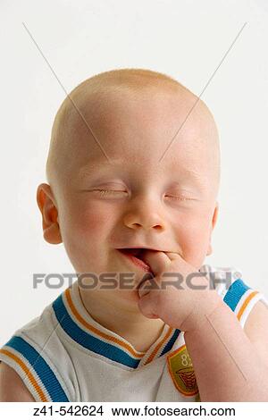 Picture - Portrait of a blond baby boy with closed eyes.. Fotosearch