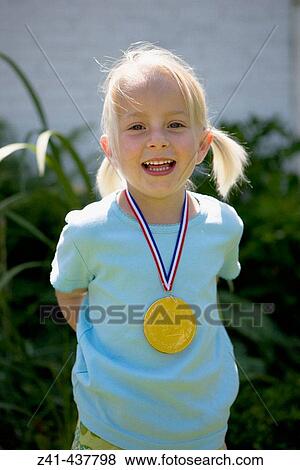 Portrait of a blond girl with a medal View Large Photo Image Stock Photo - Portrait of a blond girl with a medal. Fotosearch
