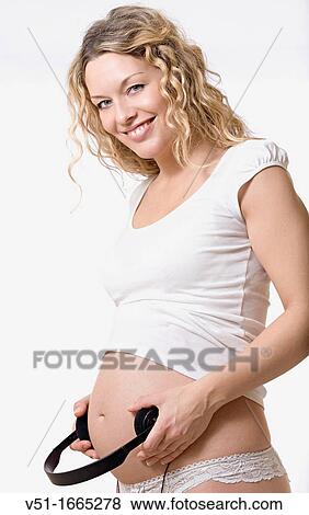 Portrait of a blonde beautiful pregnant woman with headphones in Belly View Large Photo Image Stock Photo - Portrait of a blonde beautiful pregnant woman with headphones in Belly. Fotosearch