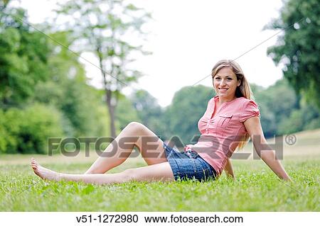 Portrait of a blonde beautiful woman sitting in the park in Spring View Large Photo Image Stock Image - Portrait of a blonde beautiful woman sitting in the park in Spring. Fotosearch
