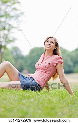 Portrait of a blonde beautiful woman sitting in the park in Spring View Large Photo Image Stock Photo - Portrait of a blonde beautiful woman sitting in the park in Spring. Fotosearch