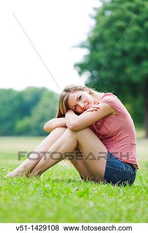 Portrait of a blonde beautiful woman sitting in the park in Spring View Large Photo Image Stock Photo - Portrait of a blonde beautiful woman sitting in the park in Spring. Fotosearch