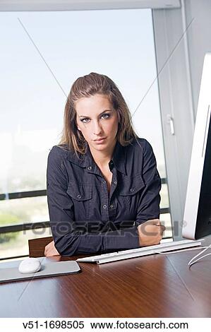 Portrait of a blonde woman at workplace with the computer View Large Photo Image Stock Photography - Portrait of a blonde woman at workplace with the computer. Fotosearch