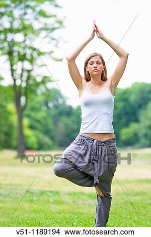 Portrait of a blonde woman doing yoga in the park View Large Photo Image Picture - Portrait of a blonde woman doing yoga in the park. Fotosearch