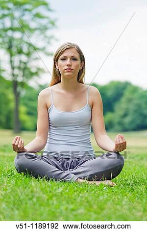 Portrait of a blonde woman doing yoga in the park View Large Photo Image Stock Image - Portrait of a blonde woman doing yoga in the park. Fotosearch