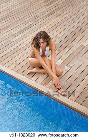 Portrait of a blonde woman relaxing by the pool View Large Photo Image Stock Image - Portrait of a blonde woman relaxing by the pool. Fotosearch