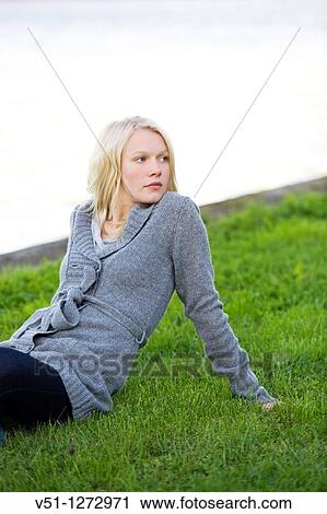 Portrait of a blonde woman sitting in the park View Large Photo Image Stock Image - Portrait of a blonde woman sitting in the park. Fotosearch