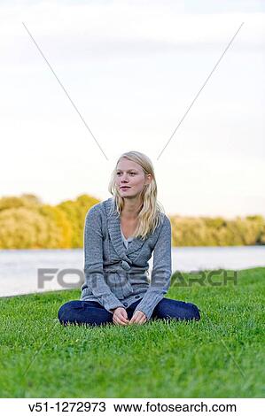 Portrait of a blonde woman sitting in the park View Large Photo Image Stock Image - Portrait of a blonde woman sitting in the park. Fotosearch