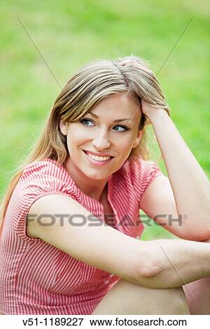 Portrait of a blonde woman sitting in the park View Large Photo Image Stock Photo - Portrait of a blonde woman sitting in the park. Fotosearch