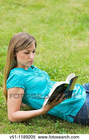 Portrait of a blonde woman with a book in the park View Large Photo Image Stock Photography - Portrait of a blonde woman with a book in the park. Fotosearch