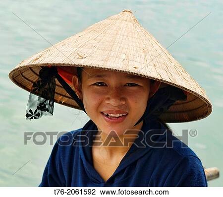 portrait of a boat vendor in Halong Bay, Vietnam. View Large Photo Image Stock Image - portrait of a boat vendor in Halong Bay, Vietnam.. Fotosearch