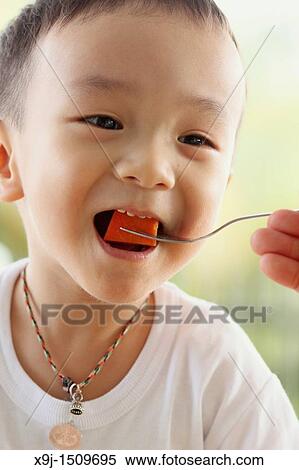 Portrait of a boy eating papaya View Large Photo Image Stock Photography - Portrait of a boy eating papaya. Fotosearch