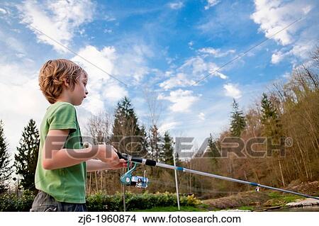 Portrait of a boy fishing trouts in the lake. Slovenia. View Large Photo Image Picture - Portrait of a boy fishing trouts in the lake. Slovenia.. Fotosearch
