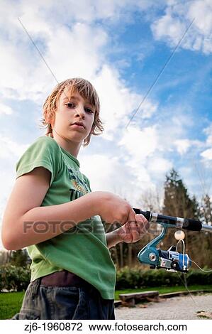 Portrait of a boy fishing trouts in the lake. Slovenia. View Large Photo Image Stock Image - Portrait of a boy fishing trouts in the lake. Slovenia.. Fotosearch