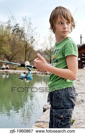 Portrait of a boy fishing trouts in the lake. Slovenia. View Large Photo Image Stock Photo - Portrait of a boy fishing trouts in the lake. Slovenia.. Fotosearch