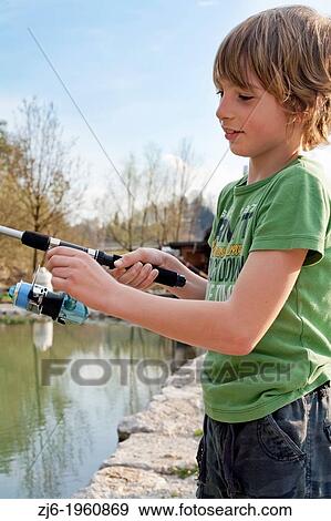 Portrait of a boy fishing trouts in the lake. Slovenia. View Large Photo Image Stock Photo - Portrait of a boy fishing trouts in the lake. Slovenia.. Fotosearch
