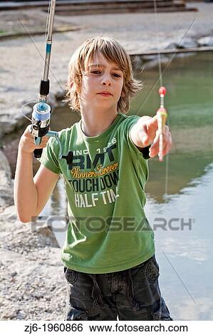 Portrait of a boy fishing trouts in the lake. Slovenia. View Large Photo Image Stock Photograph - Portrait of a boy fishing trouts in the lake. Slovenia.. Fotosearch