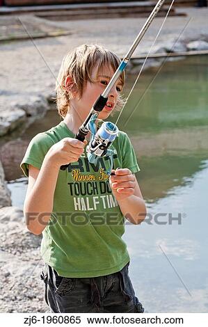 Portrait of a boy fishing trouts in the lake. Slovenia. View Large Photo Image Stock Photography - Portrait of a boy fishing trouts in the lake. Slovenia.. Fotosearch