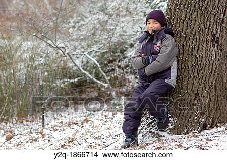 Picture - Portrait of a boy in a snowy day the park. Fotosearch