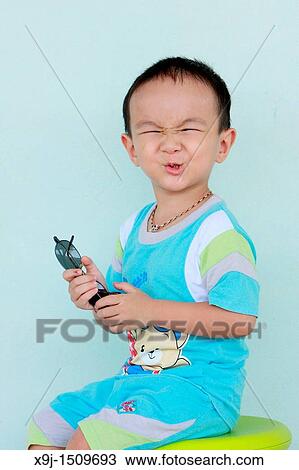 Stock Image - Portrait of a boy with funny face. Fotosearch