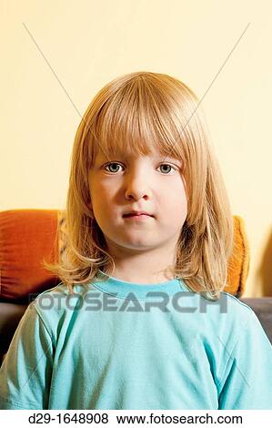 Stock Photo - portrait of a boy with long blond hair looking. Fotosearch