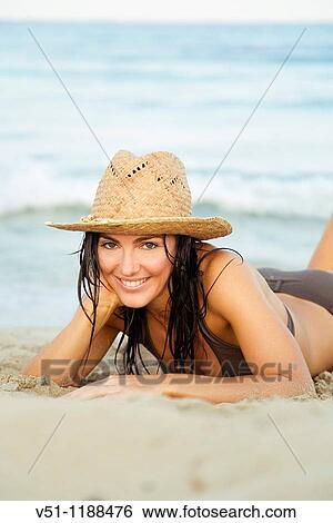 Portrait of a brunette beautiful woman laying in the beach, Ibiza, Balearic Islands View Large Photo Image Stock Photograph - Portrait of a brunette beautiful woman laying in the beach, Ibiza, Balearic Islands. Fotosearch