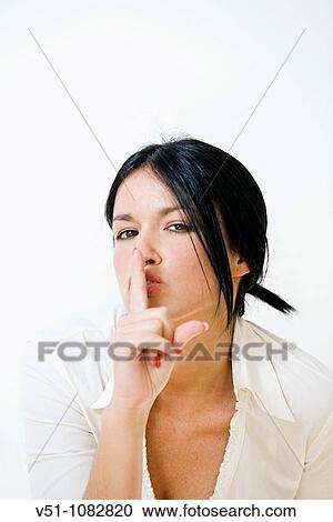 Portrait of a brunette woman asking for silence View Large Photo Image Stock Image - Portrait of a brunette woman asking for silence. Fotosearch