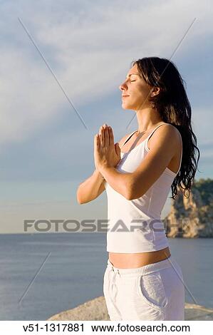 Portrait of a brunette woman doing yoga in a cliff in Ibiza, Balearic Islands View Large Photo Image Stock Image - Portrait of a brunette woman doing yoga in a cliff in Ibiza, Balearic Islands. Fotosearch