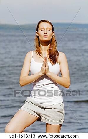 Portrait of a brunette woman doing yoga by the sea View Large Photo Image Stock Image - Portrait of a brunette woman doing yoga by the sea. Fotosearch