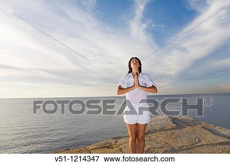 Portrait of a brunette woman doing yoga in a cliff in Ibiza, Balearic Islands View Large Photo Image Stock Photo - Portrait of a brunette woman doing yoga in a cliff in Ibiza, Balearic Islands. Fotosearch