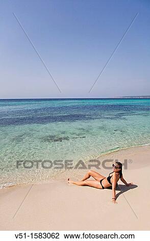 Portrait of a brunette woman relaxing at the beach in Formentera View Large Photo Image Stock Image - Portrait of a brunette woman relaxing at the beach in Formentera. Fotosearch