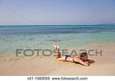 Portrait of a brunette woman relaxing at the beach in Formentera, Balearic Island View Large Photo Image Stock Photo - Portrait of a brunette woman relaxing at the beach in Formentera, Balearic Island. Fotosearch