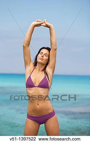 Portrait of a brunette woman stretching at the beach, Formentera, Balearic Islands View Large Photo Image Stock Image - Portrait of a brunette woman stretching at the beach, Formentera, Balearic Islands. Fotosearch