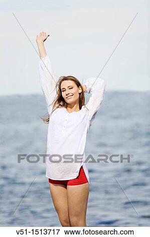 Portrait of a brunette woman stretching by the sea View Large Photo Image Stock Photo - Portrait of a brunette woman stretching by the sea. Fotosearch