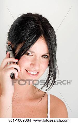 Picture - Portrait of a brunette woman talking on phone. Fotosearch
