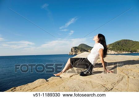 Portrait of a business woman relaxing in a cliff View Large Photo Image Stock Image - Portrait of a business woman relaxing in a cliff. Fotosearch